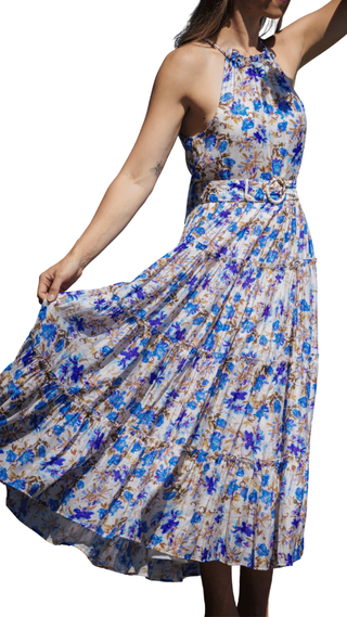 Woman wearing a floral dress with blue and white flowers on a white background