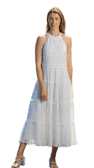 Woman wearing a light blue tiered dress on a white background