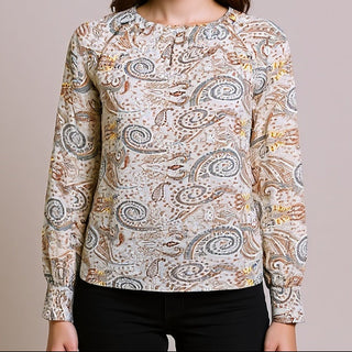 Woman wearing a Delilah Paisley Blouse against a plain background