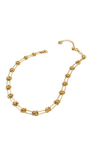 Gold chain necklace on a white background