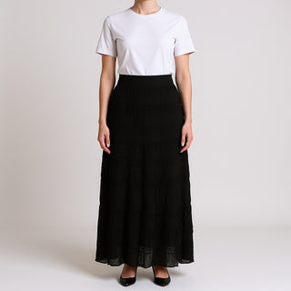 Woman wearing a white t-shirt and Soul Black Tiered Midi Skirt on a plain background
