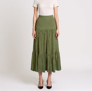 Woman wearing a white top and Soul Sage Tiered Midi Skirt on a white background