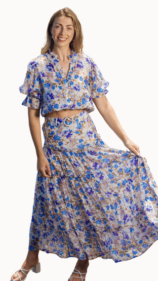 Woman wearing a floral two-piece outfit on a white background